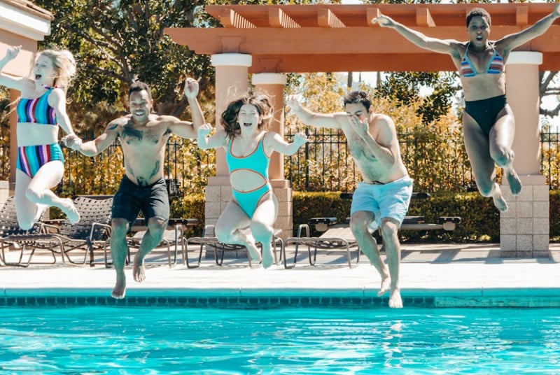 a group of people swimming in a pool of water