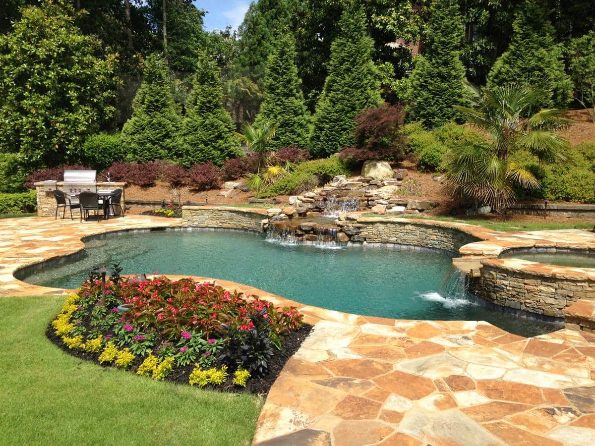 a garden with water in the background