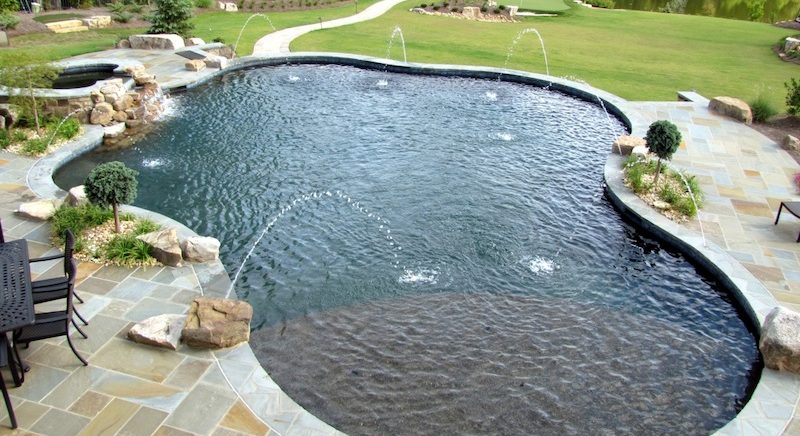 a garden with water in the background