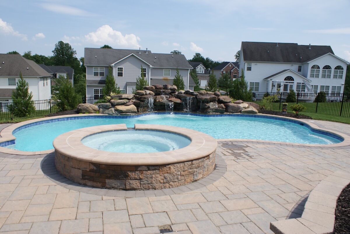 a house with a pool outside of a building